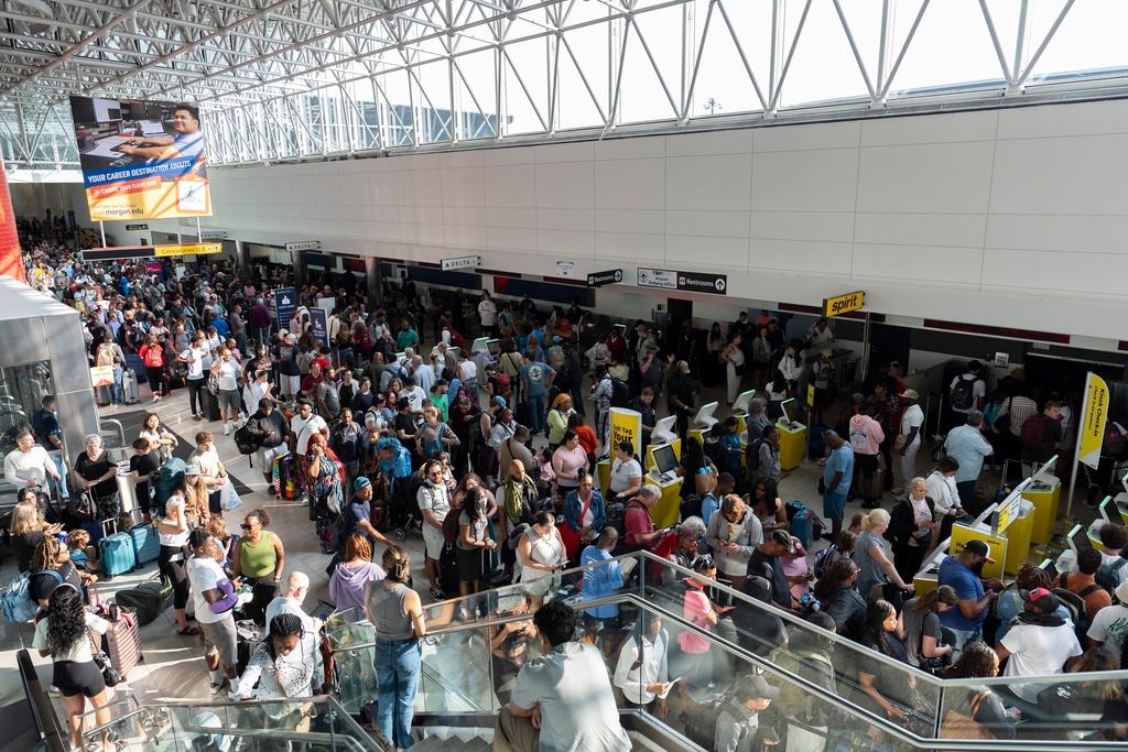 Travelers wait in line at Baltimore/Washington International Thurgood Marshall Airport in Baltimore
