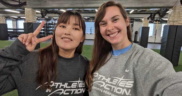 2 AIA participants smile for the camera