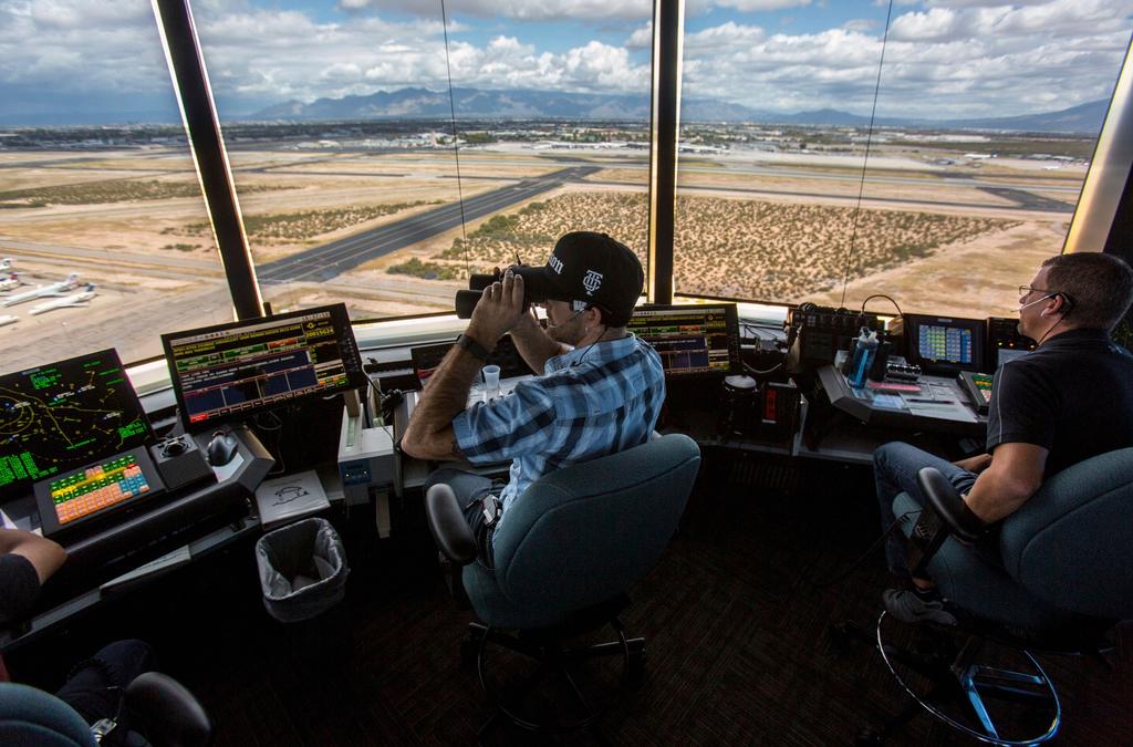 Air traffic controllers watch for traffic from the control tower at the Tucson International Airport, Friday, Sept. 23, 2016, in Tucson, Ariz.