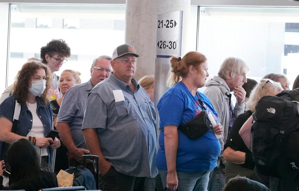 Travelers line up to board a Southwest Airlines plane at Love Field in Dallas