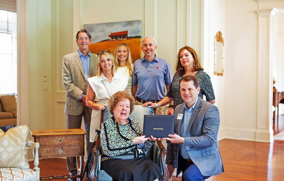 Witnessing MC President Blake Thompson presenting Rev. Barney Walker’s diploma to his daughter, Valma Walker Miller, are Walker’s family members, from left, Lee Miller, Walker’s grandson; Susan Weir, Walker’s great-granddaughter-in-law; Lucy Weir, Walker’s great great granddaughter; Trey Weir, Walker’s great-grandson; and Carol Holly, Walker’s granddaughter