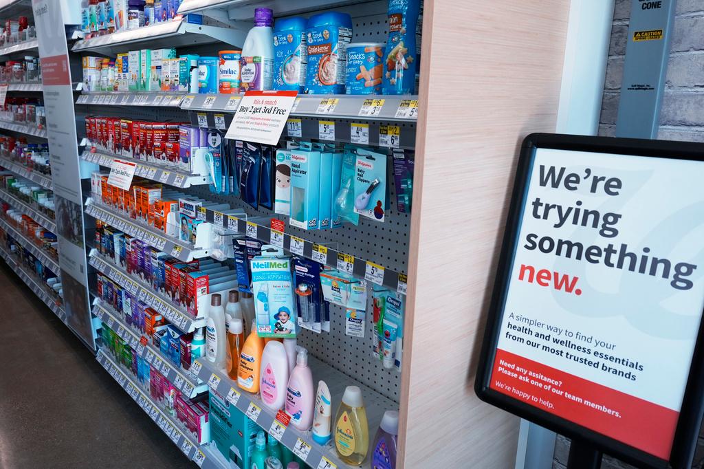 Sign is describing the store's new design is displayed at a Walgreens pharmacy store in Deerfield, Ill