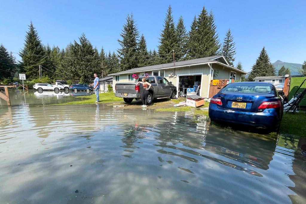 Bryan and Amy Ryder survey the damage after historic Mendenhall River flooding in Juneau, Alaska, Tuesday, Aug. 6, 2024.