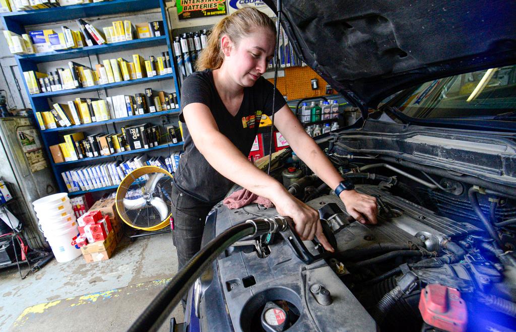 Elise Lacroix, owner of Stop & Go in Brattleboro, Vt., changes the oil on a vehicle at her shop