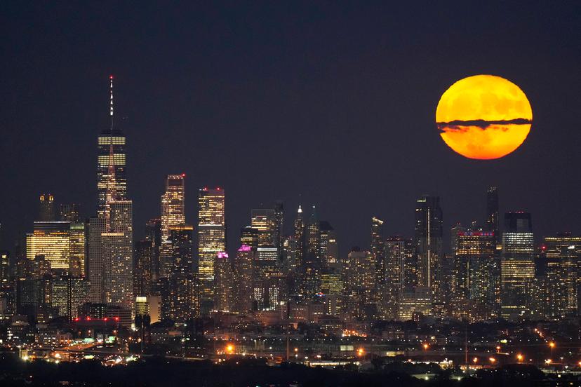 Moon rises through clouds over the skyline of lower Manhattan in this view from West Orange, N.J.
