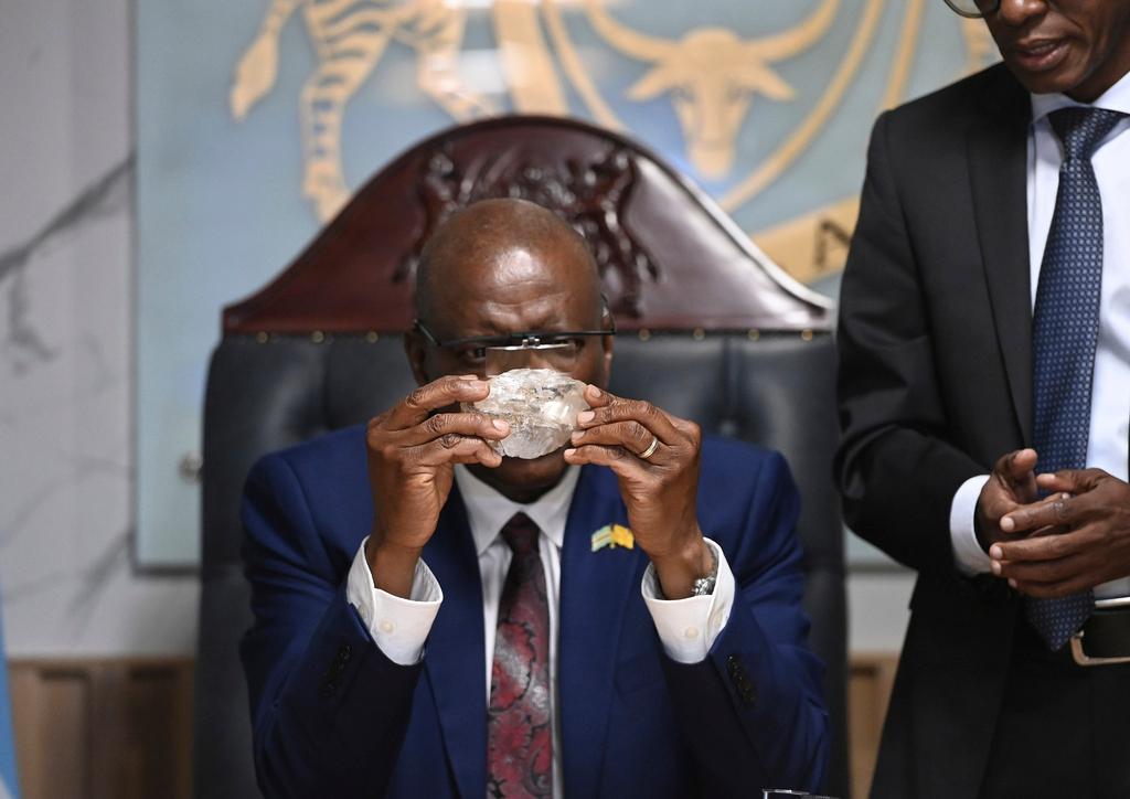 Botswana's President Mokgweetsi Masisi holds the 2,492-carat diamond that was unearthed at one of its mines 