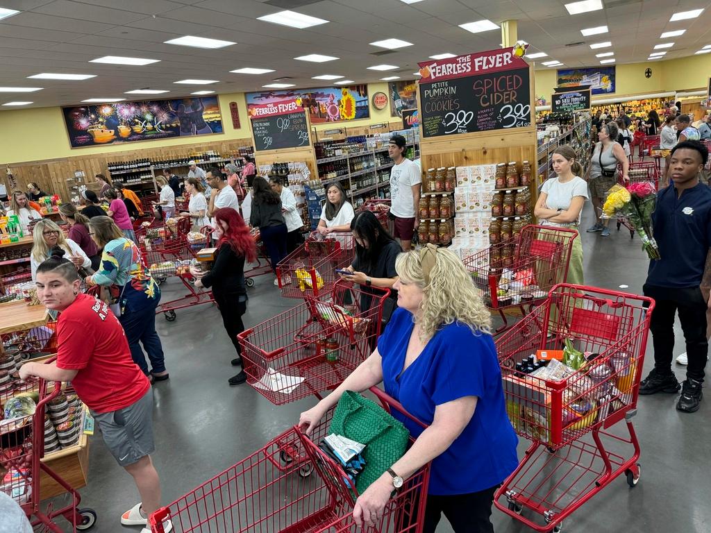 Shoppers in a suburb of New Orleans gather food supplies at a grocery store