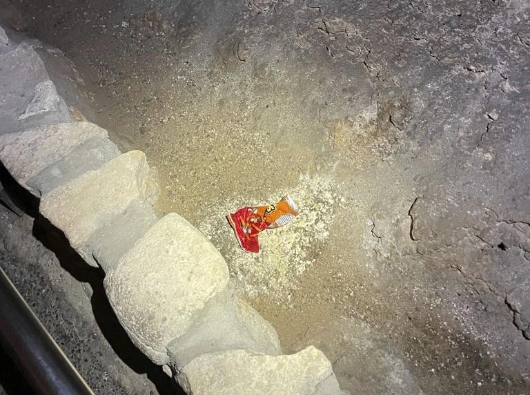 This undated photo provided by Carlsbad Caverns National Park shows a bag of Cheetos that was dropped off trail by a visitor in the Big Room at the national park near Carlsbad, N.M.