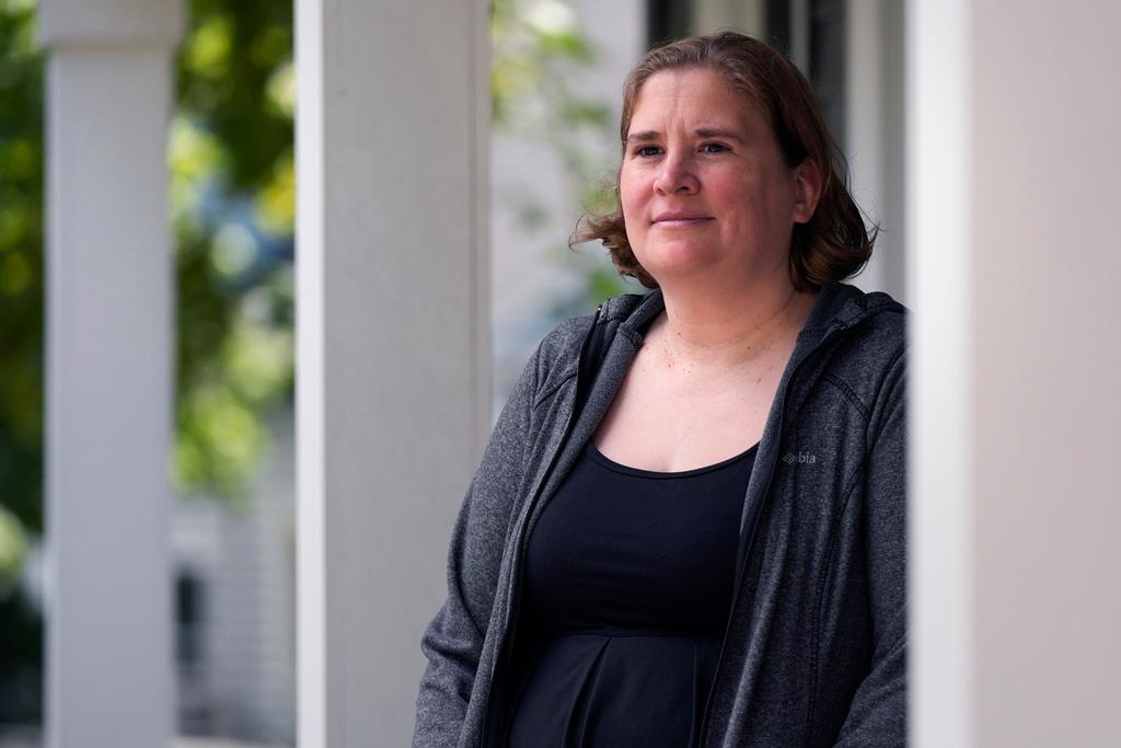 Rebecca Wood stands for a portrait outside her home, Friday, Aug. 30, 2024, in Maynard, Mass. Wood noticed a "program fee" required each time she loaded money onto her daughter's school lunch account.