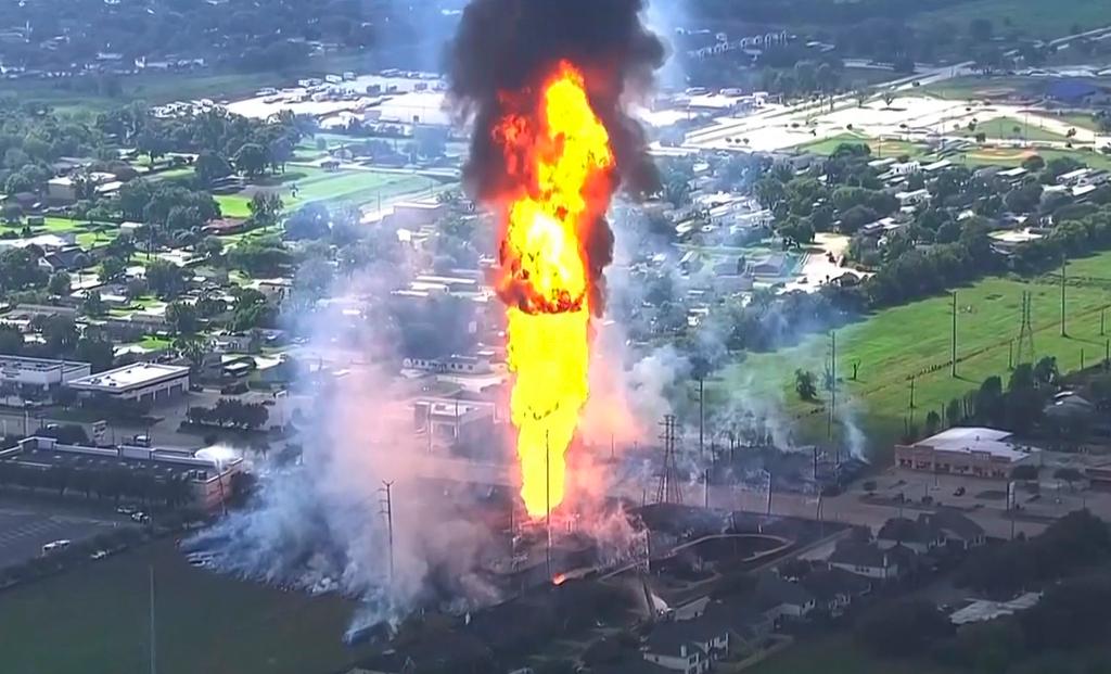 A pipeline fire in La Porte, Texas, sparks grass fires and burns power poles on Monday, Sept. 16, 2024, forcing people in the surrounding neighborhood to evacuate. 
