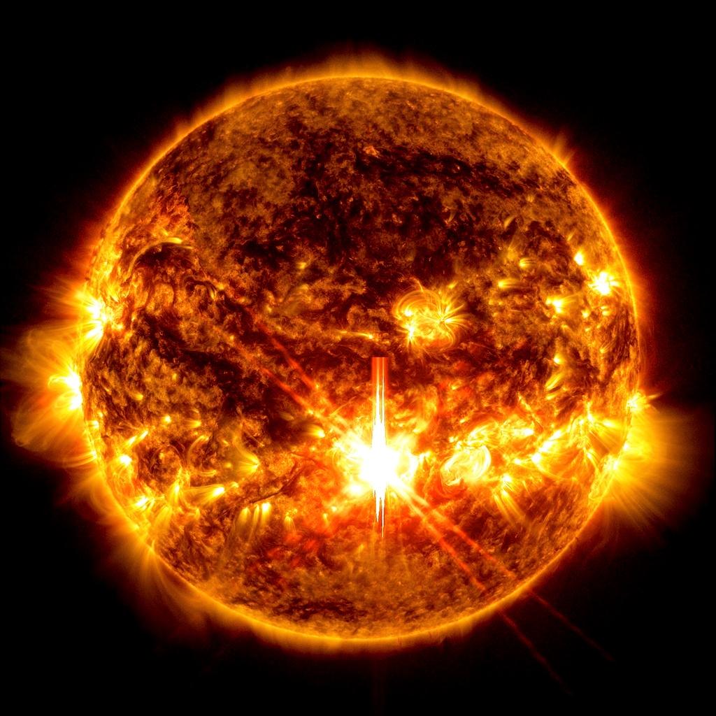 FILE - This photo provided by NASA, taken by the Solar Dynamics Observatory, shows a solar flare, the bright flash in the center of the image on Oct. 3, 2024. 