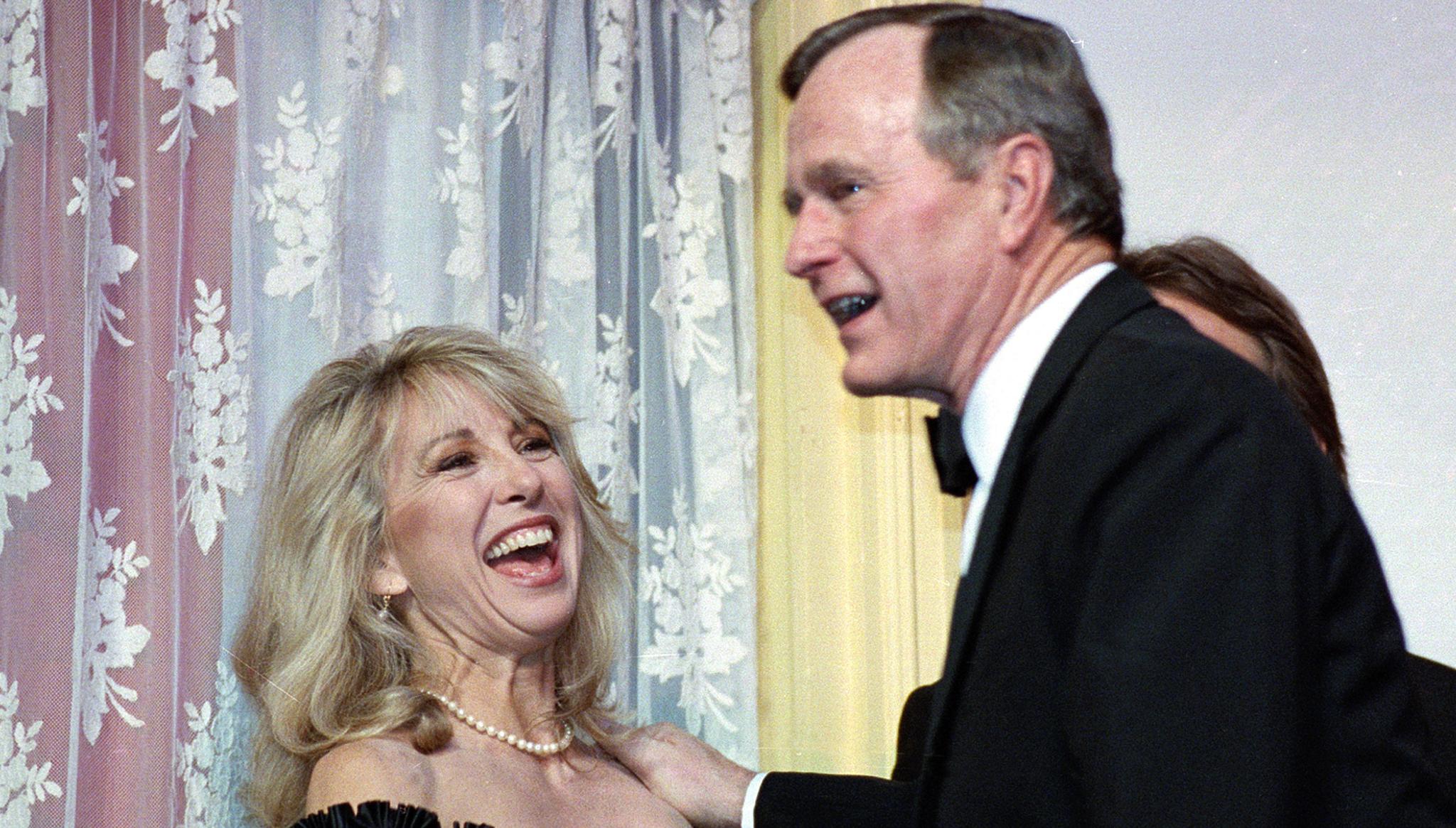 Teri Garr laughing with Pres. George H.W. Bush in a tux at a gala