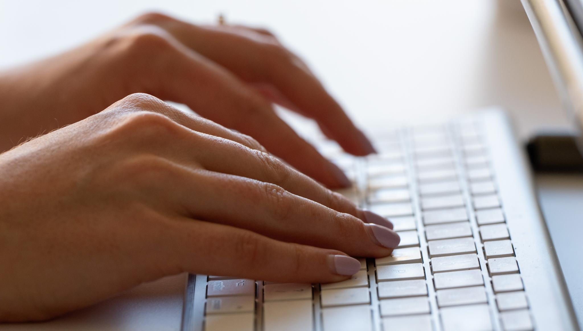 A person types on a keyboard on June 6, 2024, in Portland, Ore. 