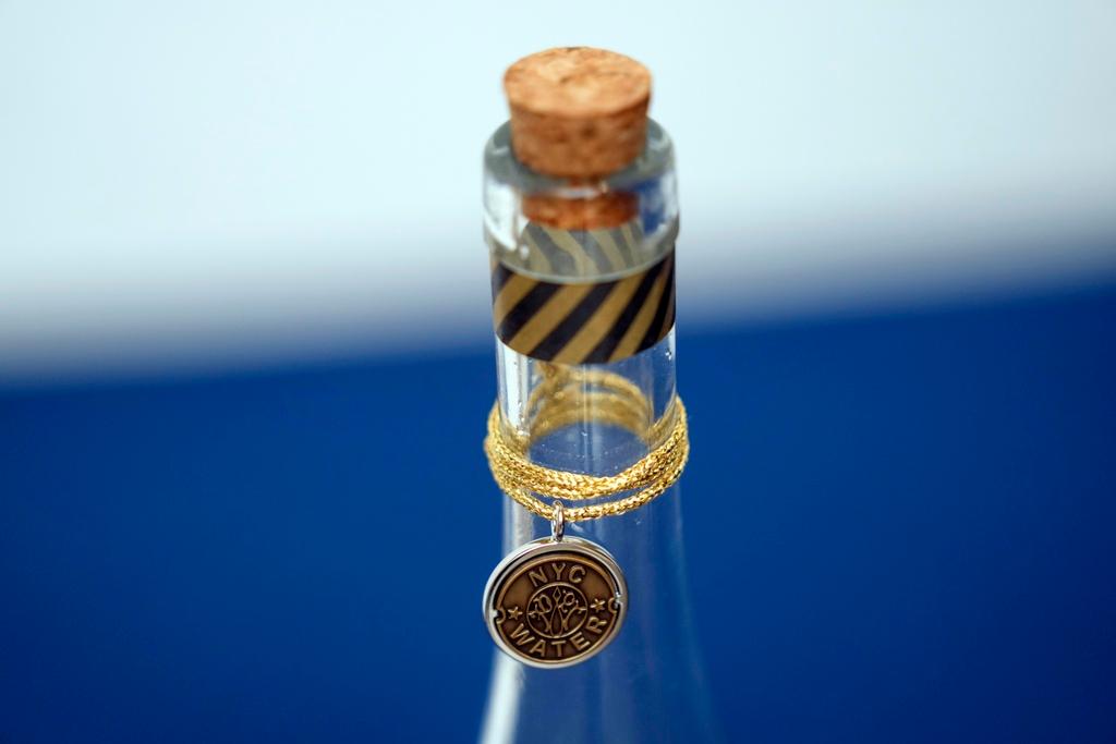 A bottle containing NYC tap water is displayed at a news conference about repairs occurring to the water supply infrastructure in New York