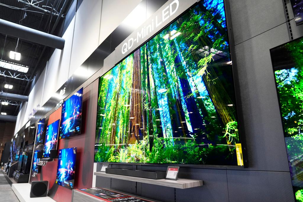 A 115-inch TCL television, right, is displayed at a Best Buy store in Dallas