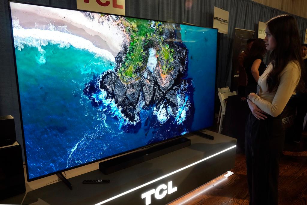 A 98-inch TCL QM-8 Q-Class Mini-LED QLED 4K HDR Smart TV is displayed at the Pepcom Holiday Spectacular event, in New York