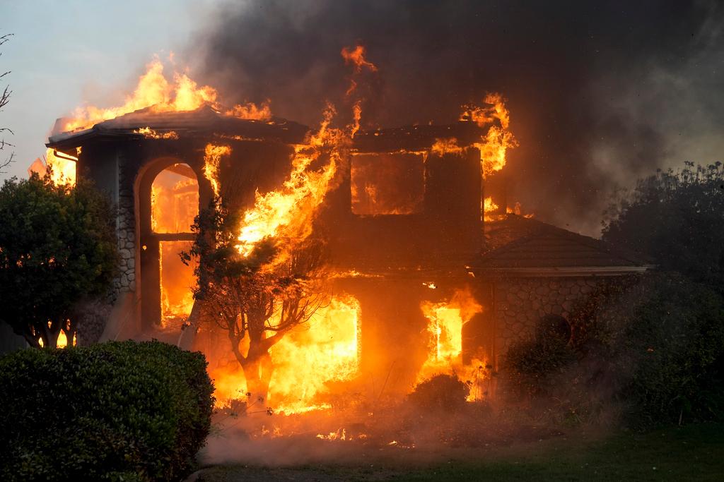 Fire burns a house in the Mountain fire in Camarillo, Calif. 