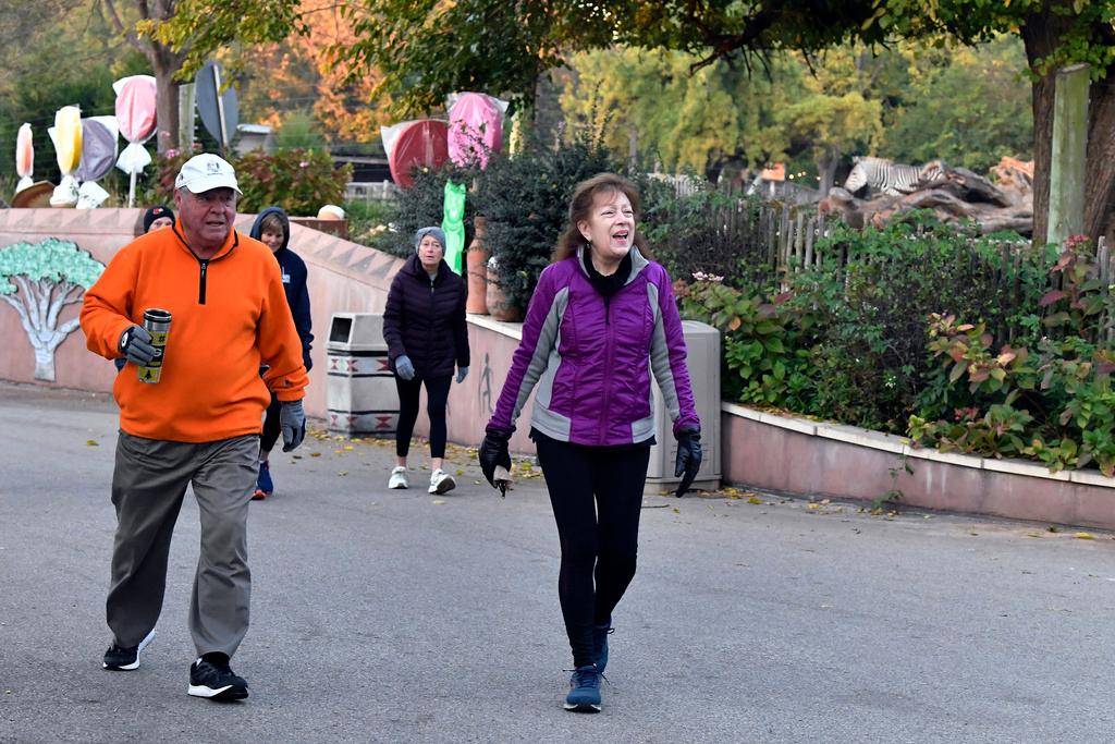 Members of the Get Healthy Walking Club walk the paths past the animal enclosures during the morning at the Louisville Zoo in Louisville, Ky., Friday, Oct. 18, 2024.