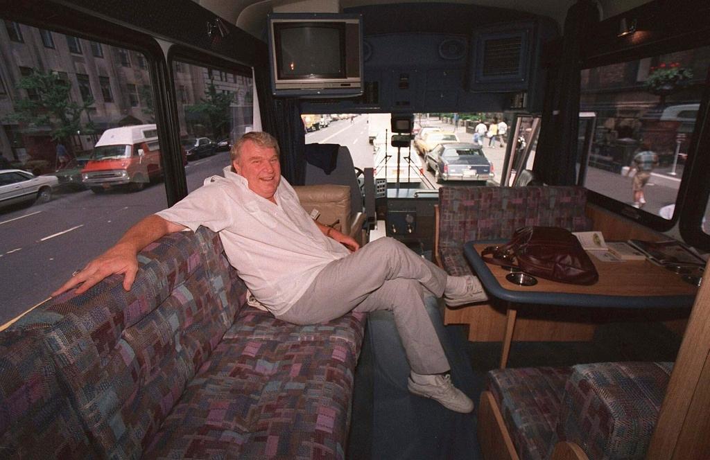 FILE - TV sports personality and former Oakland Raiders head coach John Madden enjoys the comforts of his custom-made bus while in New York June 10, 1987.