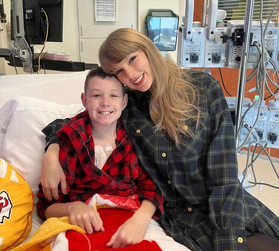 Beckett Thomas, 13, who is a patient at Children's Mercy Hospital in Kansas City, Mo., is hugged by Taylor Swift
