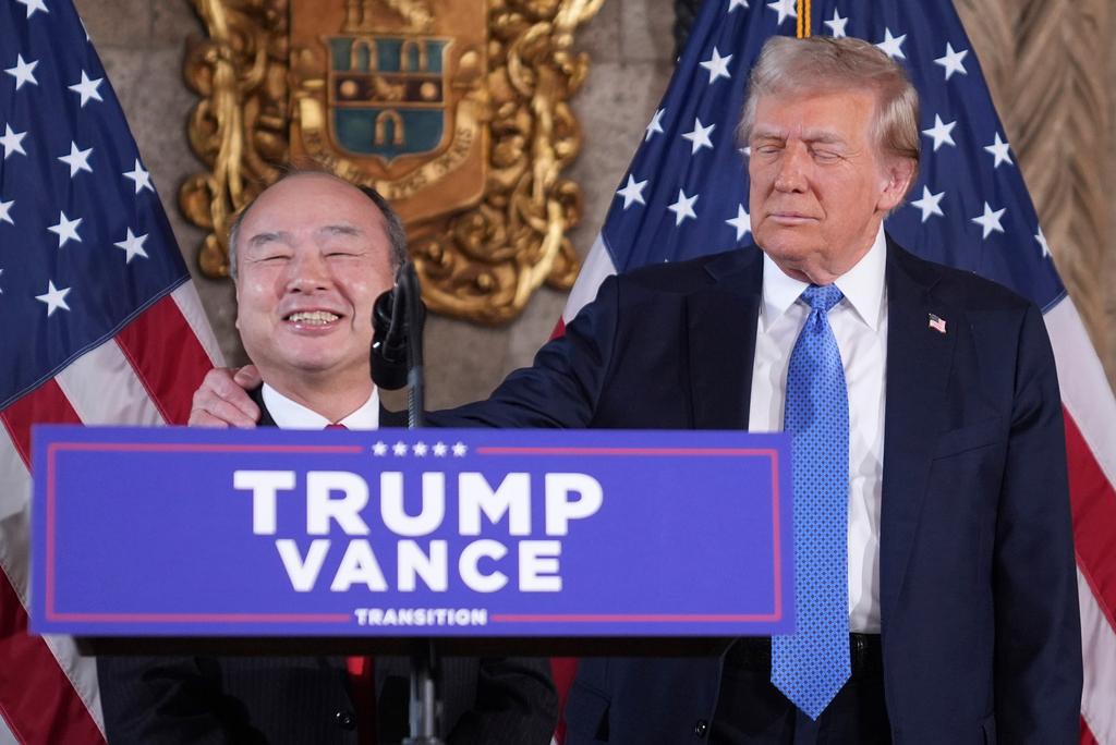 SoftBank Group CEO Masayoshi Son smiles with President-elect Donald Trump during a news conference at Mar-a-Lago