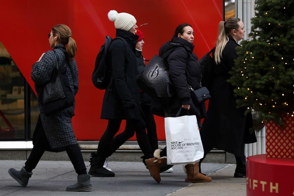 Shoppers walk along Fifth Avenue on Nov. 29, 2024, in New York. 