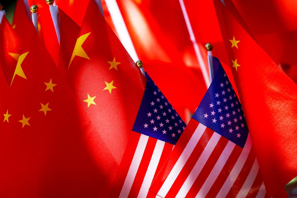 FILE - American flags are displayed with Chinese flags on top of a trishaw on Sept. 16, 2018, in Beijing. 