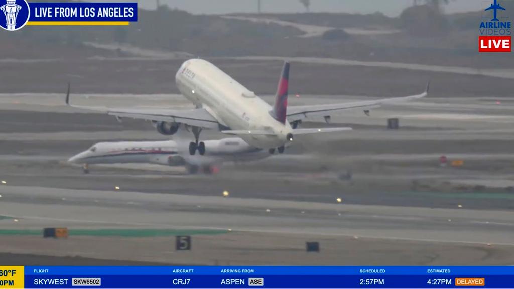 The plane operated by Key Lime Air was ordered by air traffic controllers to stop as a Delta aircraft, above, took off.