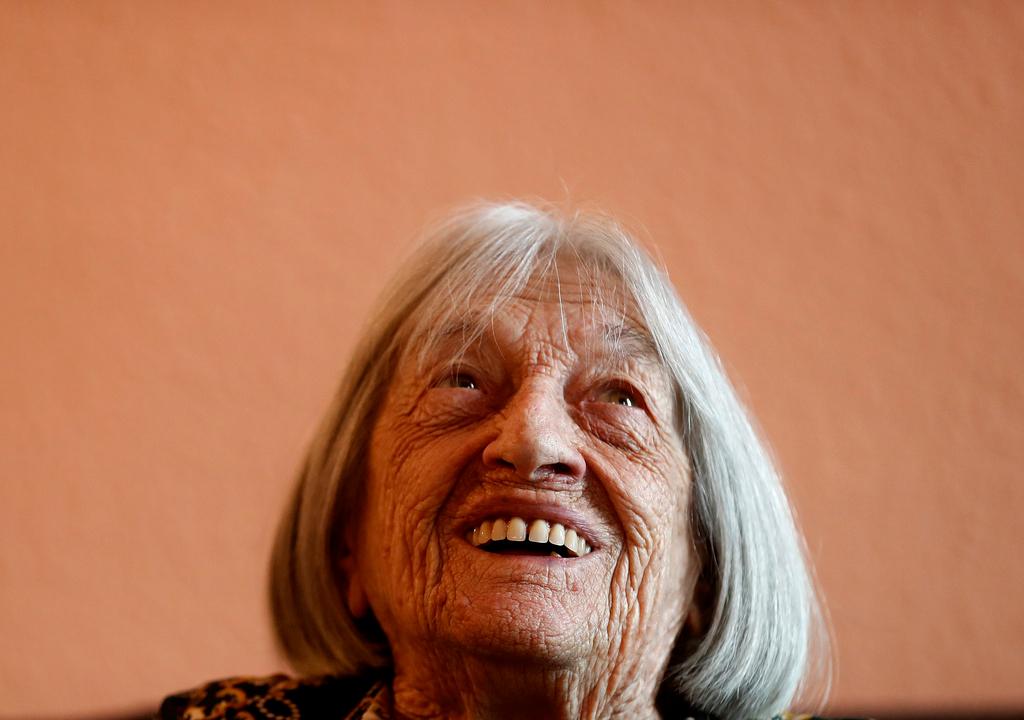 FILE - Agnes Keleti, former Olympic gold medal winning gymnast, smiles at her apartment in Budapest, Hungary Wednesday Jan. 8, 2020. 