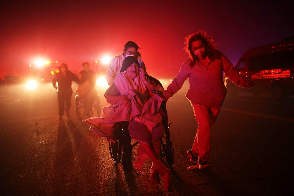 A resident of a senior center is evacuated as the Eaton Fire approaches in Altadena