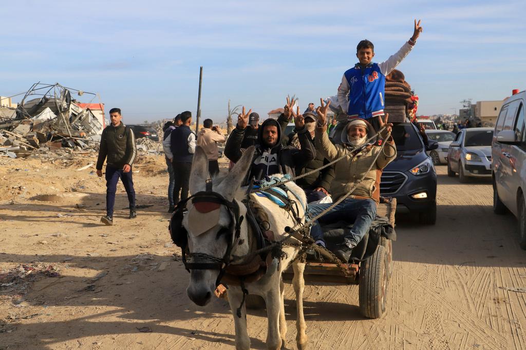 Displaced Palestinians, some armed, return to Rafah, as a ceasefire deal between Israel and Hamas went into effect, in Rafah, Gaza Strip