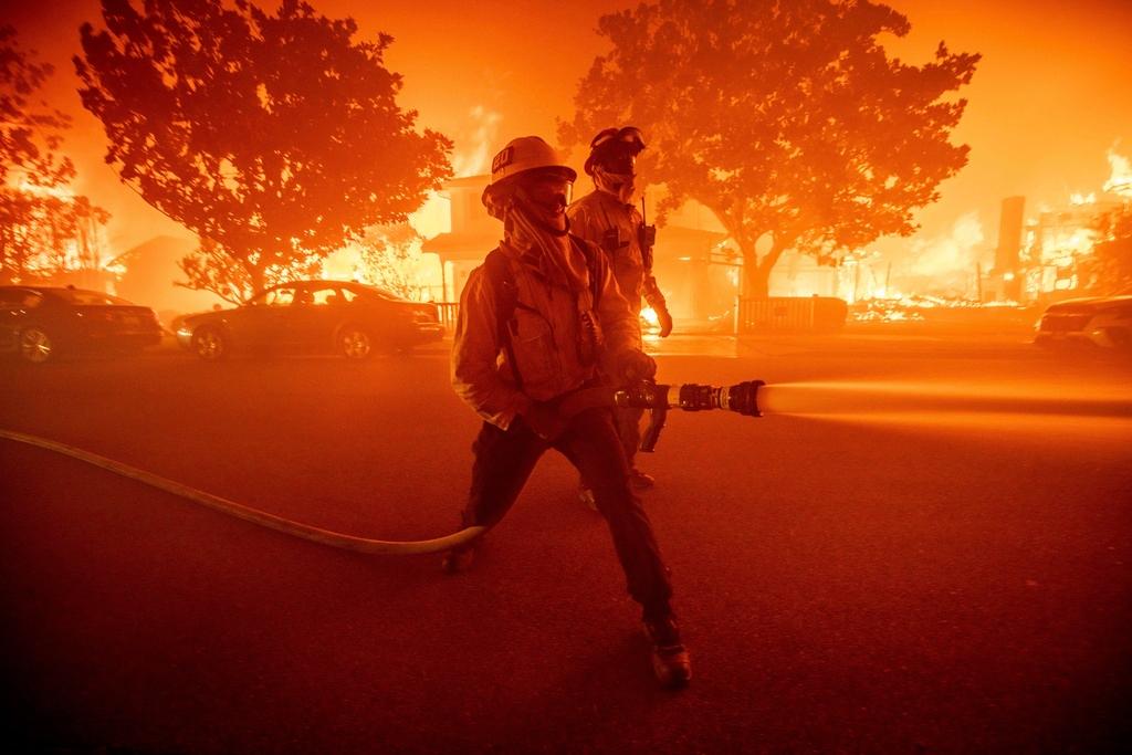 Firefighters battle the Palisades Fire as it burns multiple structures in the Pacific Palisades neighborhood of Los Angeles, Tuesday, Jan. 7, 2025.