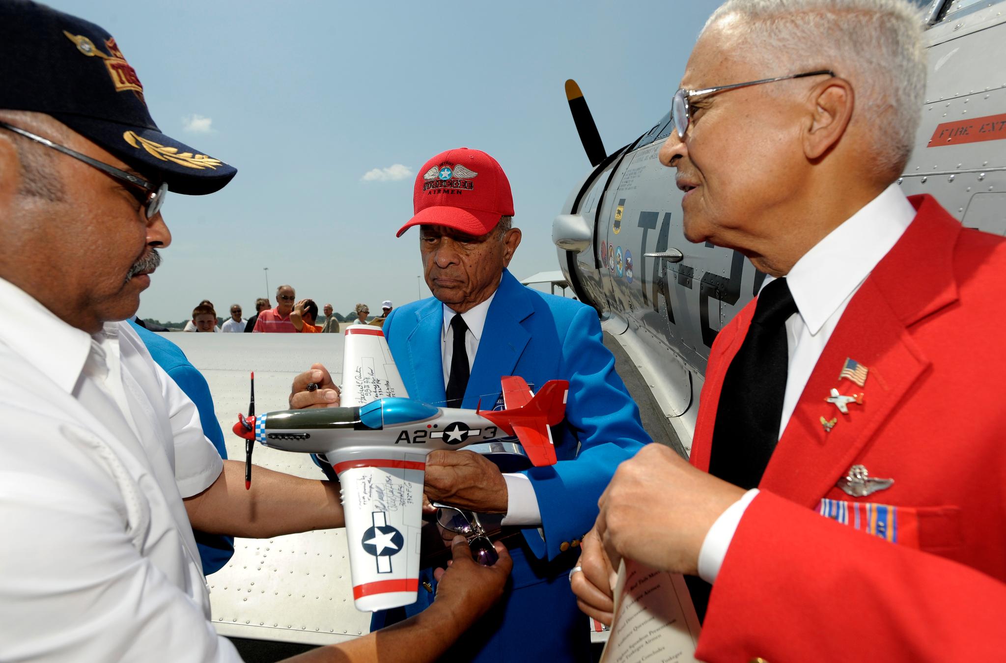 Veteran airmen gathered near a fighter jet