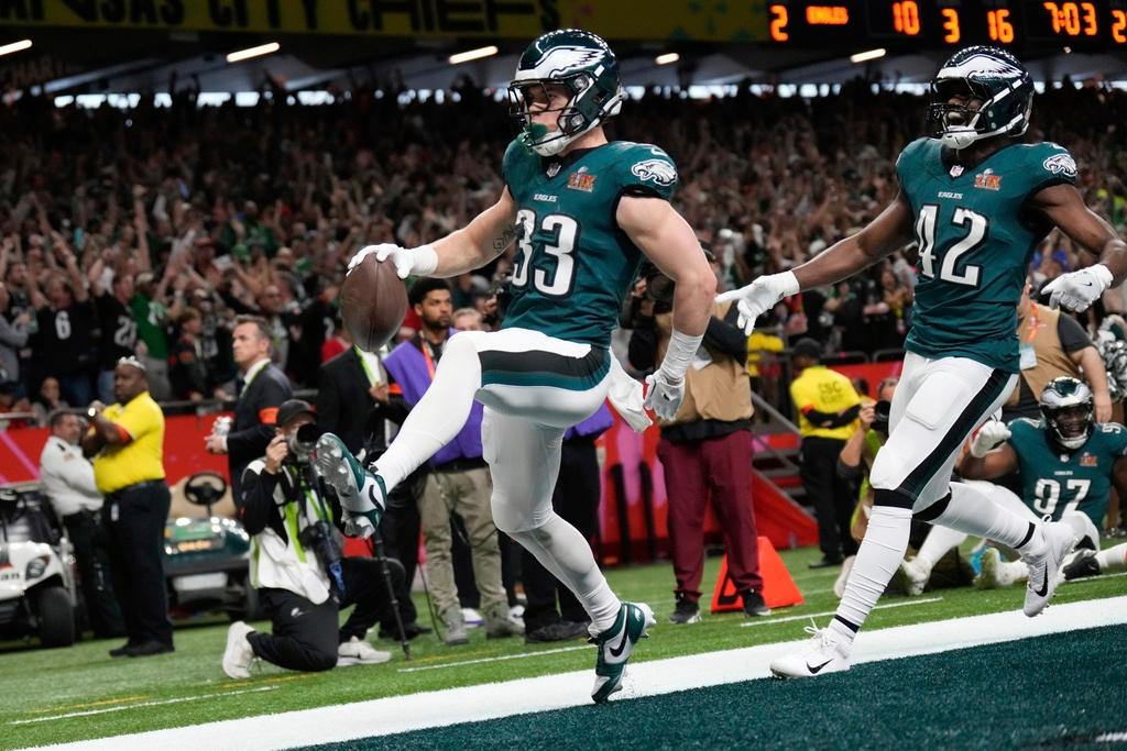 Philadelphia Eagles defensive back Cooper DeJean (33) scores a touchdown after intercepting a pass during the first half of the NFL Super Bowl 59 football game