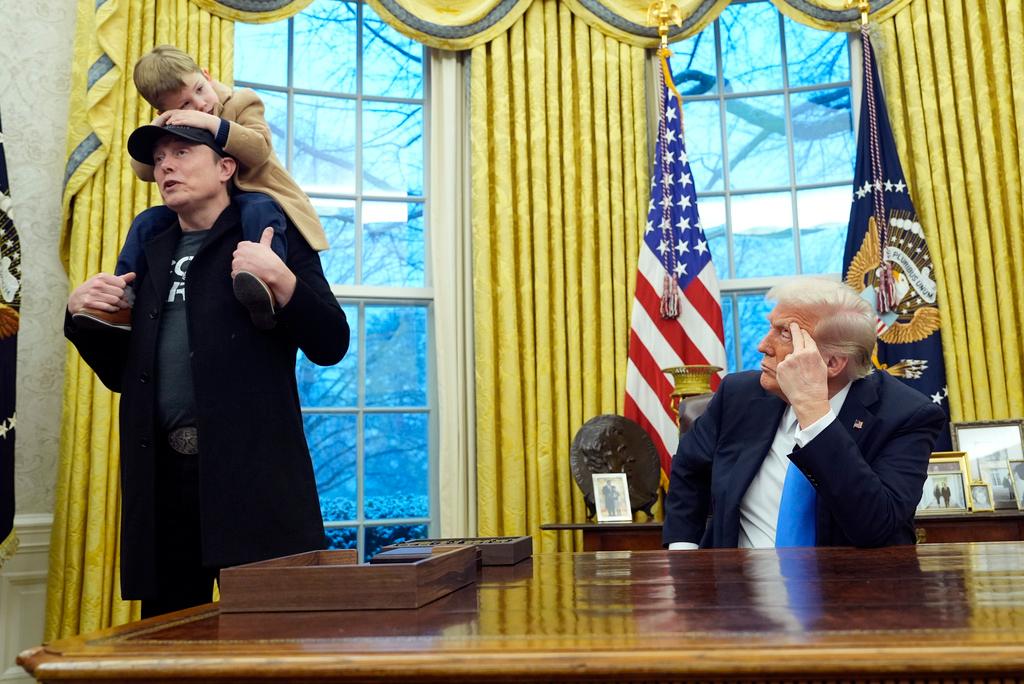 Musk stood next to the Resolute Desk with his young son as Trump praised Musk's work with his Department of Government Efficiency to slash spending 