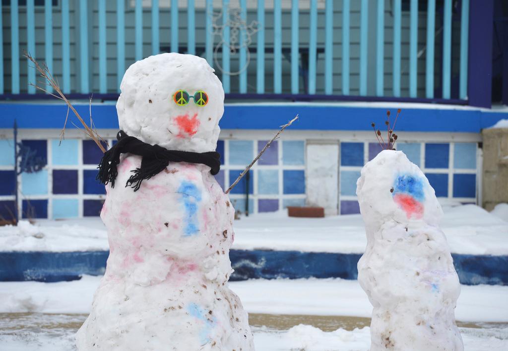 A pair of snowmen appear in St. Joseph, Michigan