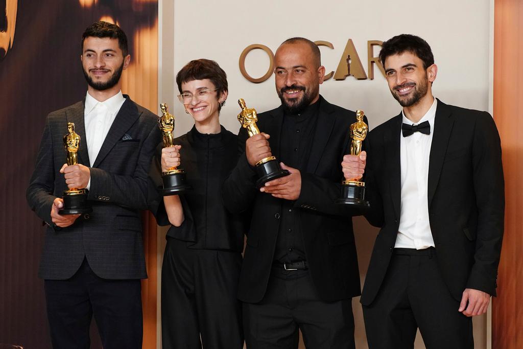 Basel Adra, from left, Rachel Szor, Hamdan Ballal, and Yuval Abraham, winners of the award for best documentary feature film for "No Other Land," pose in the press room at the Oscars on Sunday, March 2, 2025, at the Dolby Theatre in Los Angeles. 