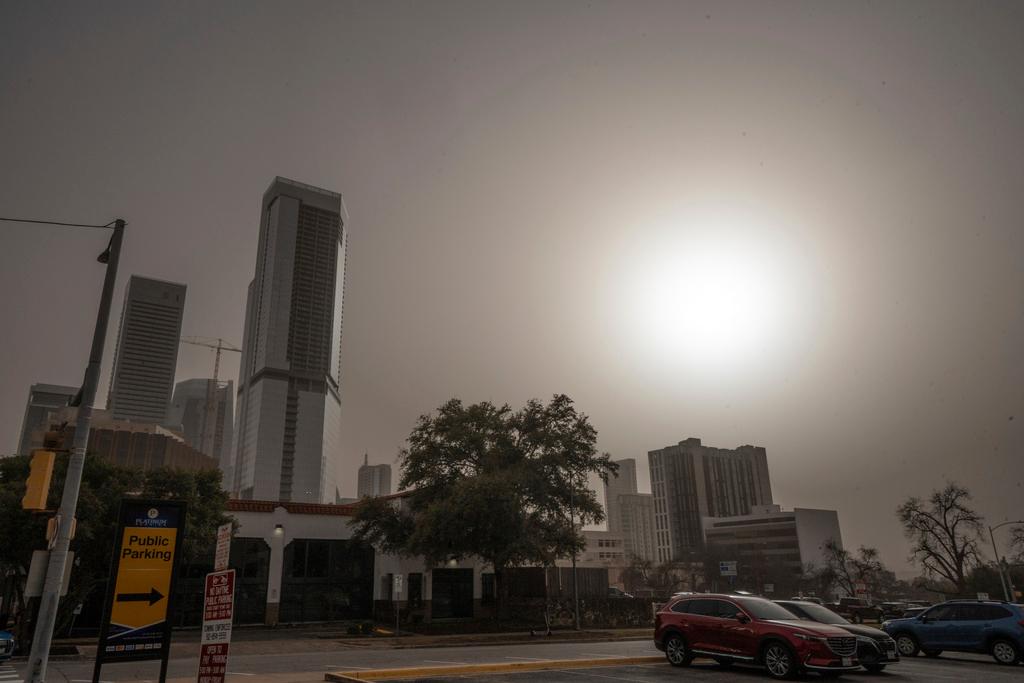 Eerie: Dust from West Texas brought in by high winds obscures the sun over downtown Austin