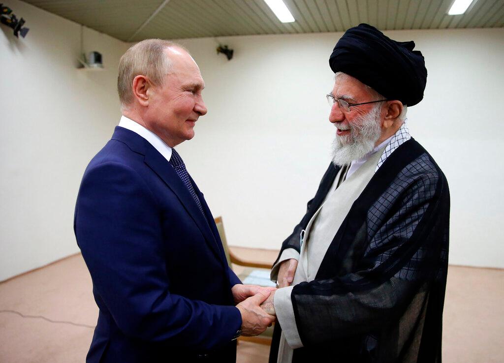 Iranian supreme leader, Supreme Leader Ayatollah Ali Khamenei, right, and Russian President Vladimir Putin greet each