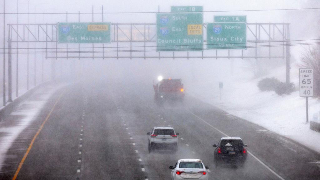 Vehicles follow a snow plow on eastbound I80 during a blizzard in Omaha, Neb. 