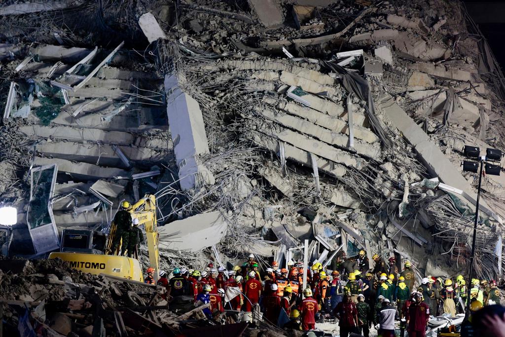 Rescuers work at the site a high-rise building under construction that collapsed - Bangkok 