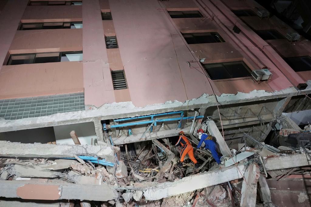 Rescuers search for survivors at a collapsed building in the aftermath of an earthquake in Mandalay, Myanmar