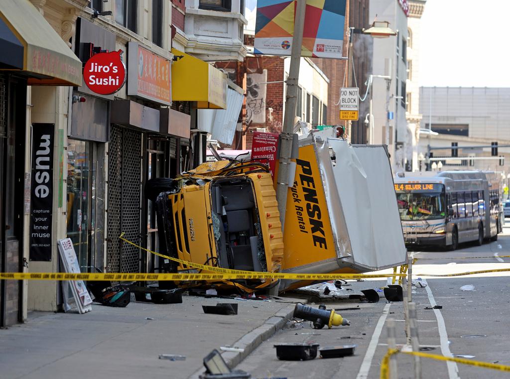A box truck rests on a sidewalk following a crash, which injured several people in the Chinatown neighborhood of Boston on Tuesday April 1, 2025.