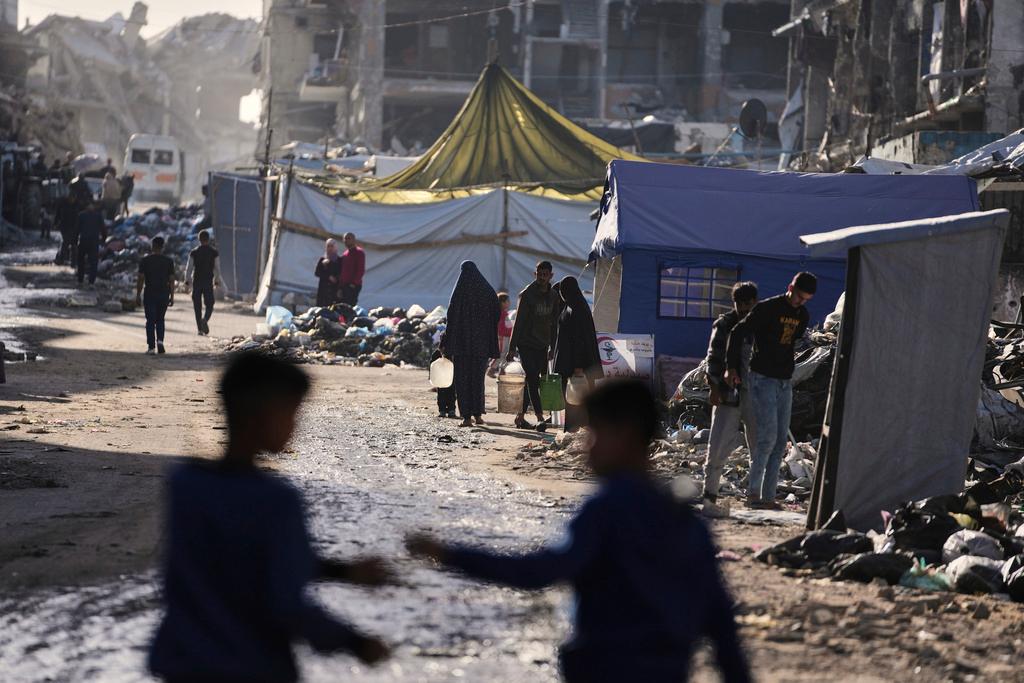 FILE - Displaced Palestinians carry water in Jabaliya, Gaza Strip on Monday, March 31, 2025.