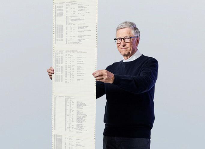 Microsoft founder Bill Gates holding a printout of the computer coding that launched the software maker in April 1975.