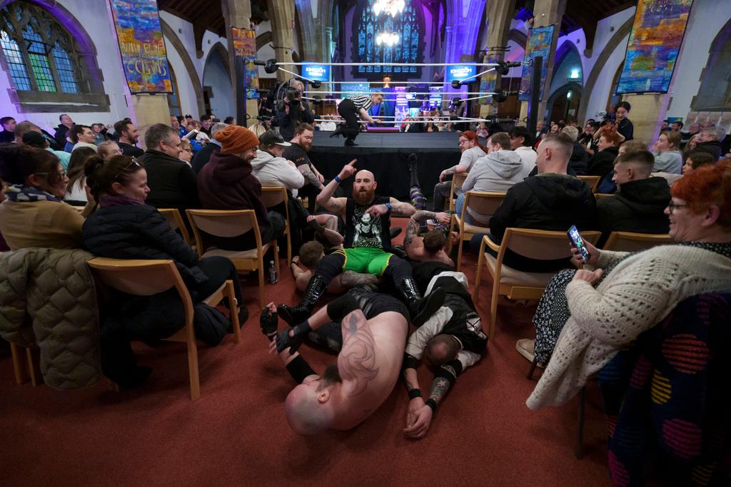 A six-man-scramble spills out of the ring at a Kingdom Wrestling show at St Peter's Church in Shipley