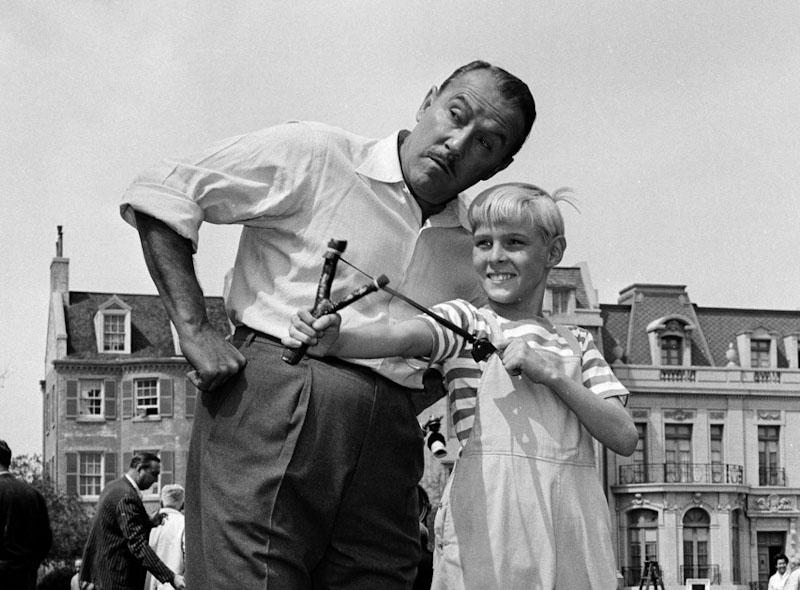 Actor Jay North, in character as Dennis the Menace, shows his ever-present slingshot to show co-star Gale Gordon, on set in Hollywood