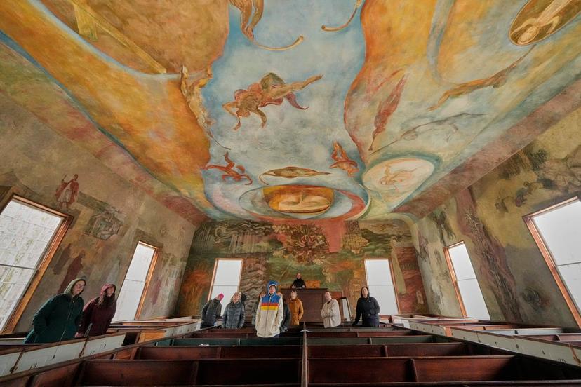 Visitors view the frescoes at the South Solon Meeting House, in Solon, Maine. 