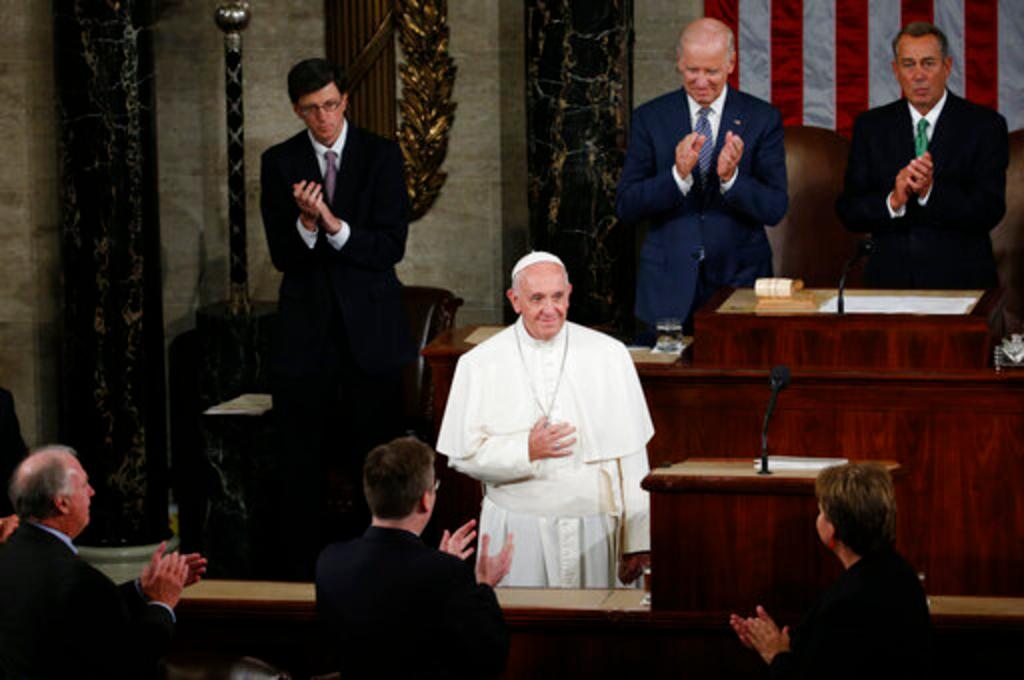 (2015) US Vice President Joe Biden, second from right at top, and House Speaker John Boehner of Ohio and others applaud Pope Francis as he arrives to address a joint meeting of Congress on Capitol Hill in Washington, making history as the first pontiff to do so