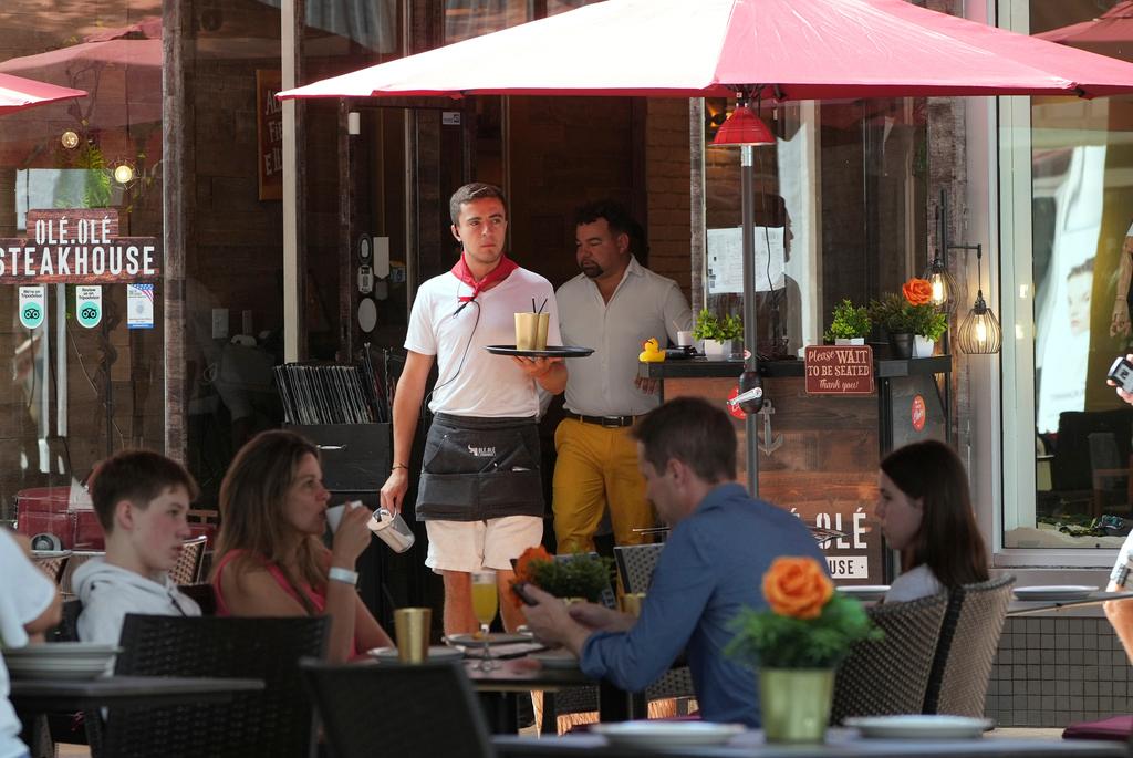 waiter carries drinks in Miami Beach job employment 